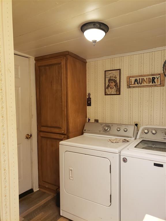 The utility area has storage for towels and cleaning supplies.