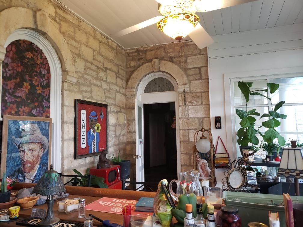 Enjoy another view of the sunroom with the original limestone doorway.