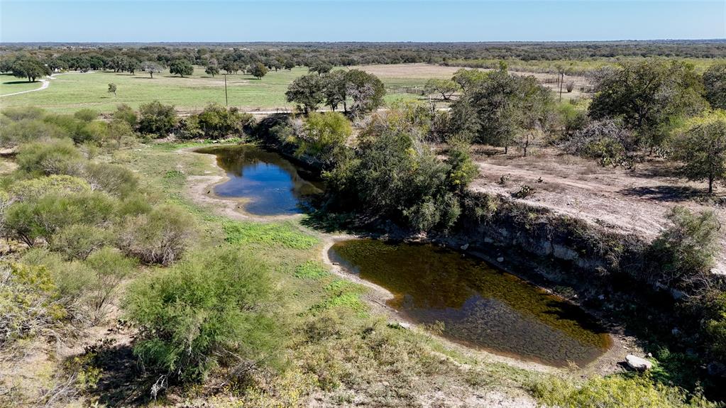 Welcome to the Bouldin Ranch, 214 acres in Gonzales County, TX. The ranch features 4 ponds, large oak trees, working pens, and 8,775 ft. of road frontage on 3 different sides. This is the perfect ranch to run cattle and build a dream home and start your own legacy ranch. The ponds are amply placed all throughout the property providing adequate water to livestock and wildlife. Trails and roads have recently been cut throughout the land giving access to all parts of the ranch. A beautiful quarry pond in the southeast corner of the ranch is an attractive place to spend time, hunt ducks and dove, picnic, or just enjoy the country side. A new gate and entrance was constructed on CR 301 which leads straight to a camp site surrounded by a dry creek bed and a myriad of beautiful oak trees. 10 minutes from US 183, and a short 1 hour and 15 minute drive from Austin or San Antonio. The 3 sides road frontage also gives way to development opportunities now, or in the future.