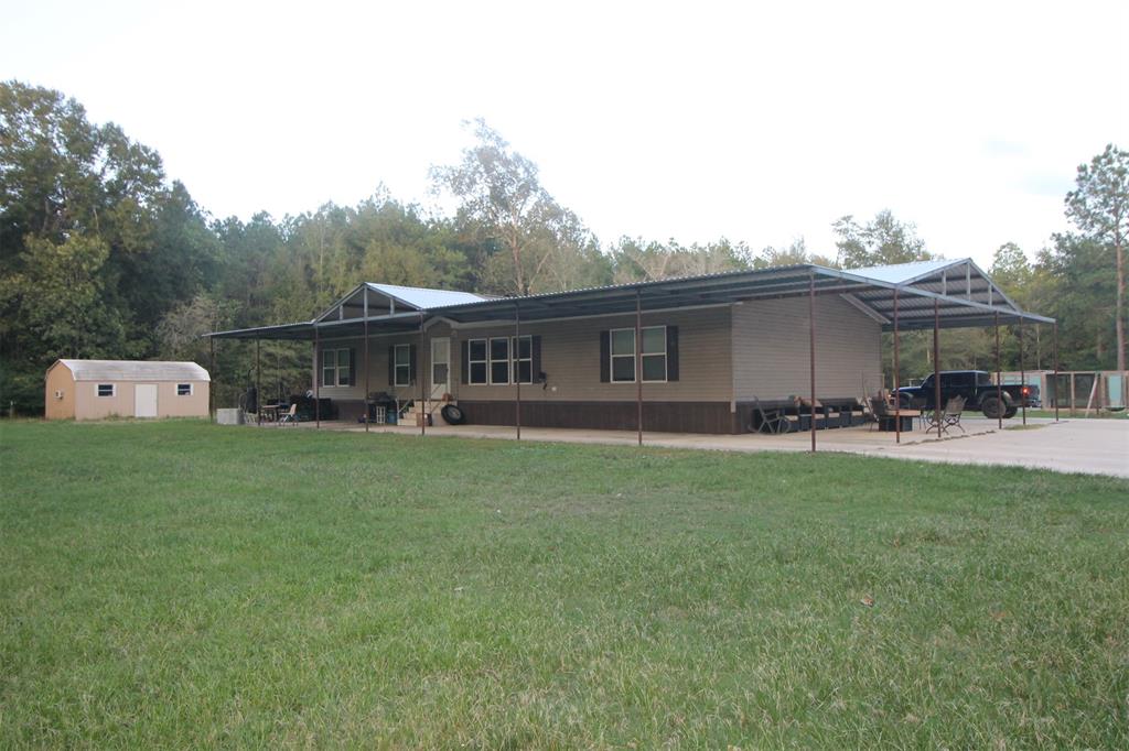 20130 Highway 146 Liberty, Texas TWO great homes located on 16.64 acres! This property features two mobile homes, a 4 BR 2 Bath that is 2340 SF and has a metal roof cover and concrete pad on 3 sides extending 12' making for tons of parking and patio space. The second mobile home is also a 2017 model and has 1456 SF including 3BR and 2 Baths. The second home includes a covered front porch and a huge, covered deck on the rear. It also includes a two-car detached carport with enclosed shop space as well as several outbuildings for storage. Each home has its own septic. Both homes sit well off the road and share a common driveway. The section of the land is heavily wooded with lots of deer and other wildlife. This property is perfect for large families than need multiple homes. Don't miss out on this opportunity to own such a unique property, make your appointment today!