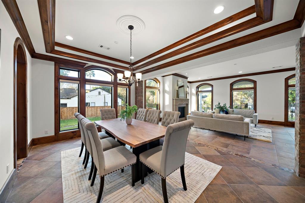 A spot made for sophisticated gatherings, the open dining area showcases tray ceilings, picture windows, and generous accommodations for a large group of guests while leaving plenty of room to move around.