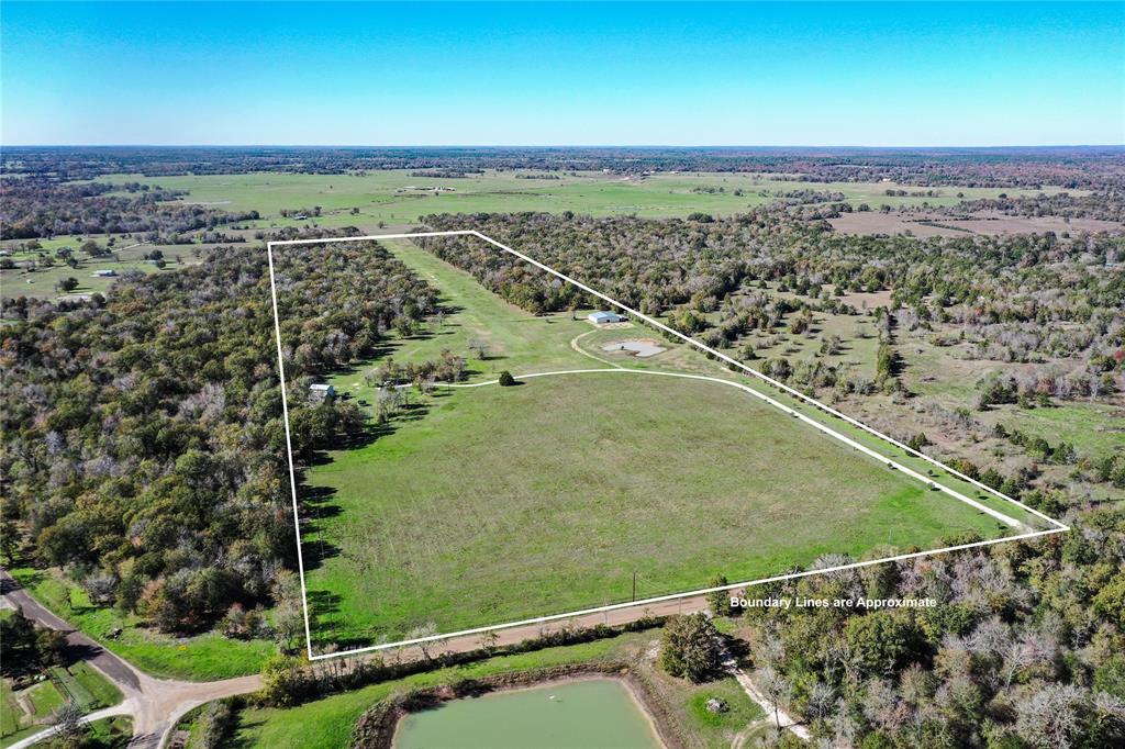 Welcome to Trinity Field (TA82), a truly versatile and one-of-a-kind 69-acre estate located in the heart of Madison County! The property offers a Charming Custom Home, a 60x60 Hangar, Hay Fields, and a Grass Air Strip. Situated down a tree-lined drive, the 2,276-sf home offers 2 spacious bedrooms, 1-bathroom, large living spaces, wood-burning fireplace, and covered porch overlooking the runway. Outdoor amenities include RV hook-ups, full-fencing w/ pipe-fencing along the front, native pecan and persimmon trees, a 384’ water well, chicken coop & run, addt. T-hangar, improved hay field, 0.25-ac stocked pond and currently AG EXEMPT. Airstrip is an FAA-registered 2450’ x 50’ 10/28 grass strip. Hangar is metal construction with concrete floors, perfect for multiple aircraft or farm equipment. Located minutes from I-45, this property is an easy drive or short flight to College Station OR Houston. 1.5 HOURS FROM IAH. Call for prospectus, interactive maps, and to schedule your private tour!