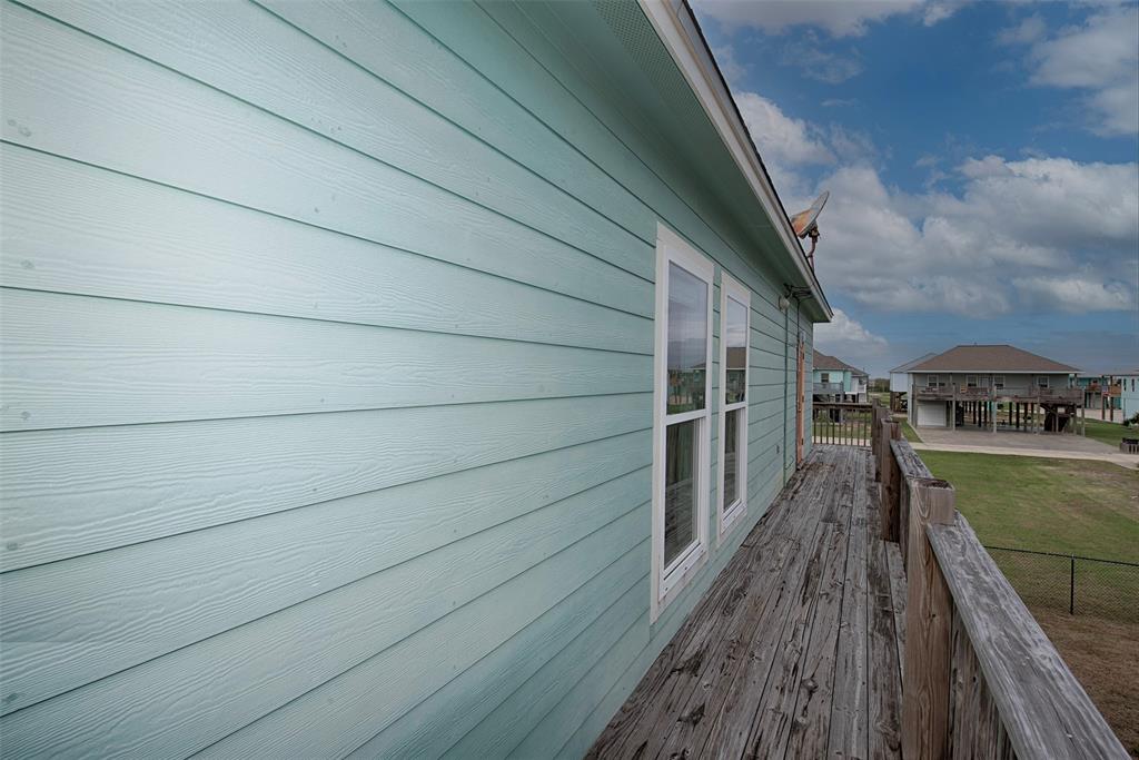 Deck wraps around the home with secondary door to the primary bedroom.