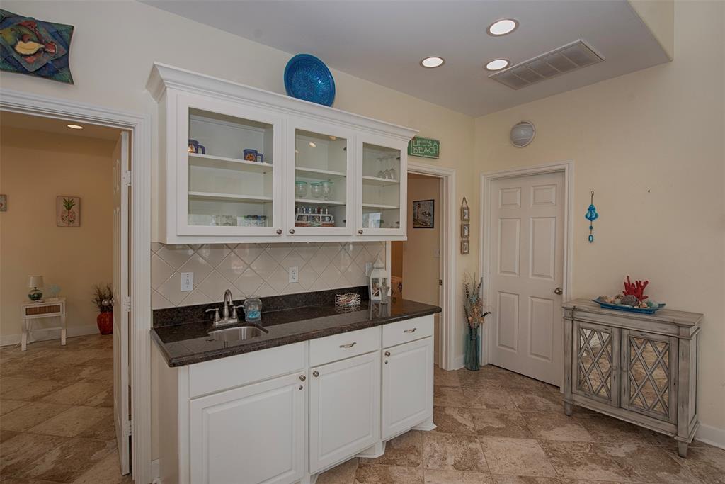 There is even a wet bar with great built in cabinetry for showcasing your stemware and spirits.