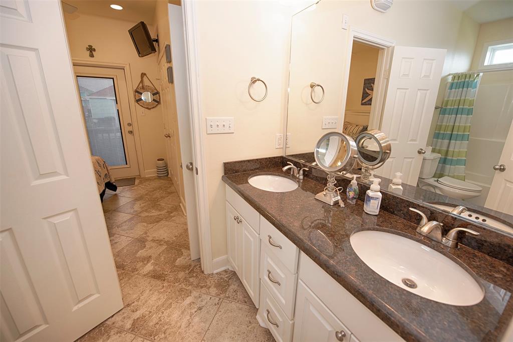 Between the primary bedroom and the family room is a Jack n\' Jill bathroom with double vanity with granite counters.