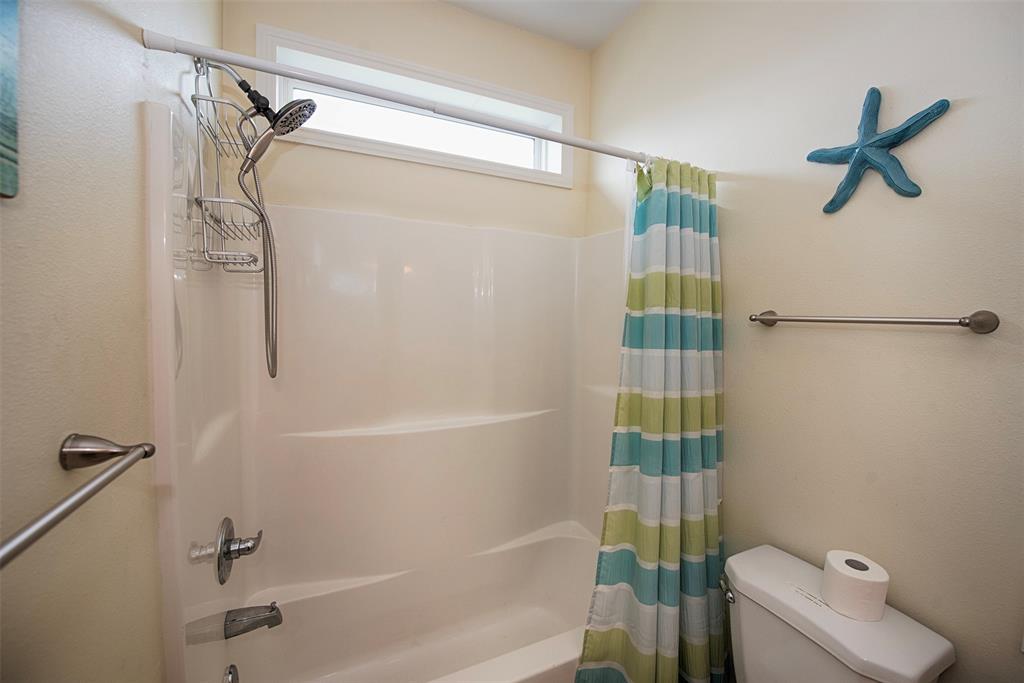 Bathroom also features a combo bath and shower.