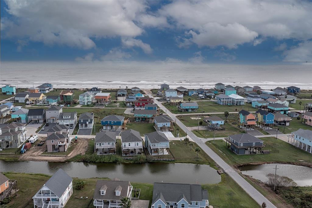 An aerial view from above the home showing the ponds just a block away and the short distance to the beach. Just grab your golf cart an enjoy a day of swimming and fishing.