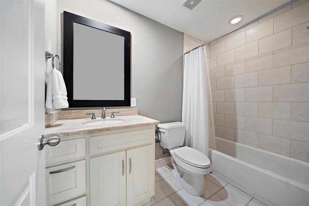 The secondary ensuite bath is complete with a vanity area, ample cabinet space, plus a shower and tub combo.