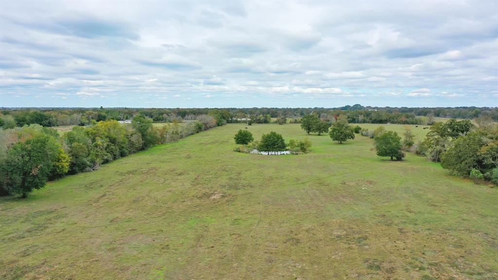 Beautiful, unrestricted 25.00 +/- acre property offers several choice building sites and a convenient location between Madisonville and Bryan/College Station with quick access to Hwy 21.  This parcel is regular in shape with slightly sloped terrain allowing for good drainage and presents approximately 95% open and 5% wooded with scattered hard and softwoods.  Amenities include perimeter fencing (+/-90%) and a pond perfect for watering livestock or stock it with your favorite fish. Providing wide open spaces, this property offers so many possibilities: Build your dream home and have plenty of room for horses, livestock or gardening. Excellent opportunity for a future development, farm or recreational land. Electricity is nearby; water well and septic will need to be added by the new owner.  This property has an agriculture exemption already in place and is currently used for cattle. Experience the quiet countryside while being in close proximity to shopping, dining and entertainment.