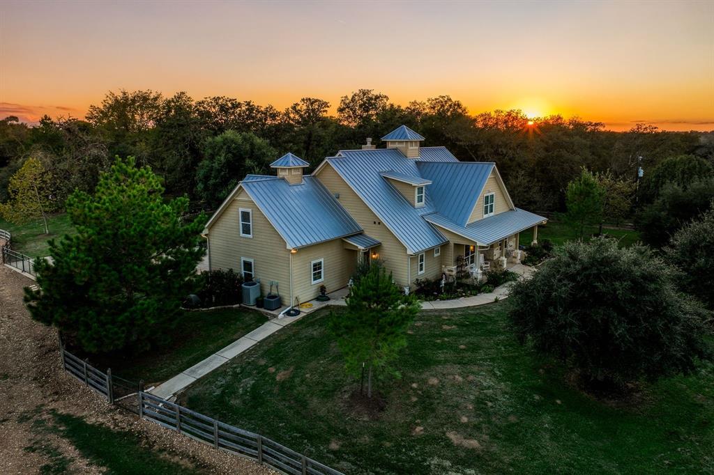 Spectacular 220.50 +/- acre (per ACAD) ranch, 2,527 sq. ft. (per Seller), 4/3/2 custom-built home, outside of Bellville, with park-like interior yard. Multi-functional barn/shed/shop, horse shed with stalls, vintage barn, outbuildings, and a 1949 rental home (1,098  sq. ft. per ACAD) round out the improvements. Rolling hills, impressive elevation change (approx. 80 feet), roughly 1.2 miles of road frontage on two county-maintained roads, four ponds, several branches/wet-weather creeks and just under a mile of West Mill Creek frontage. Ag. exempt. (cattle/hay), several build sites, open and wooded areas, towering pecan trees, grazing meadows for native wildlife, cattle, horses, and other livestock.  Roughly 45 miles to Katy and 21 miles to Round Top. The tranquil setting interspersed with livestock, native wildlife and beautiful scenery make this a stunning property to experience.  Rare opportunity to own a large block of land in historic and highly sought after Austin County, Texas.