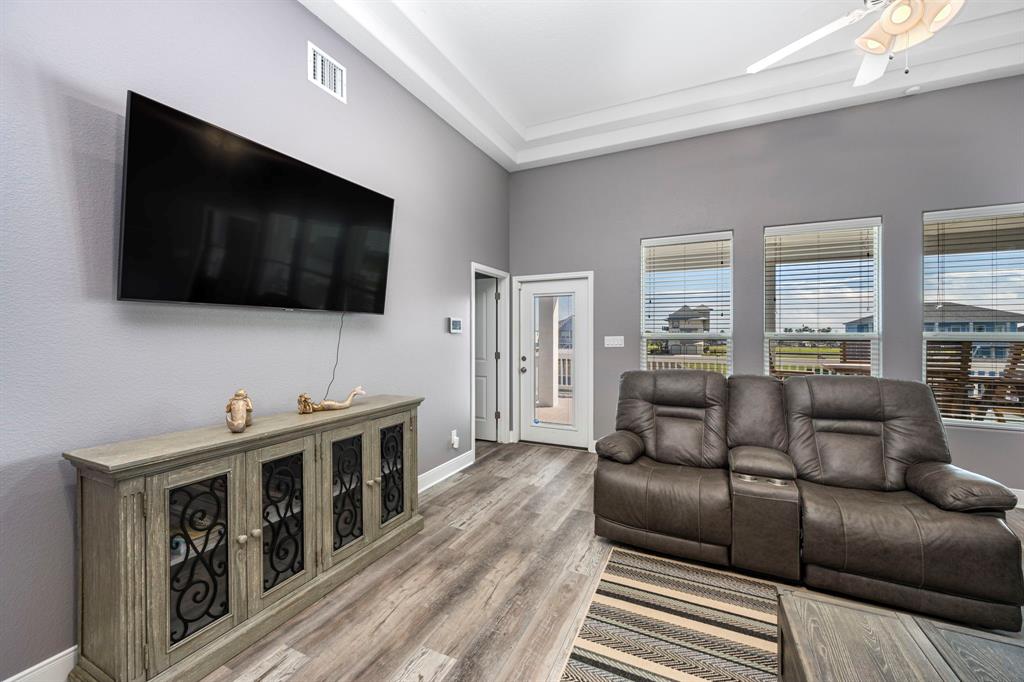 Living Room with neutral colors and tray ceiling.