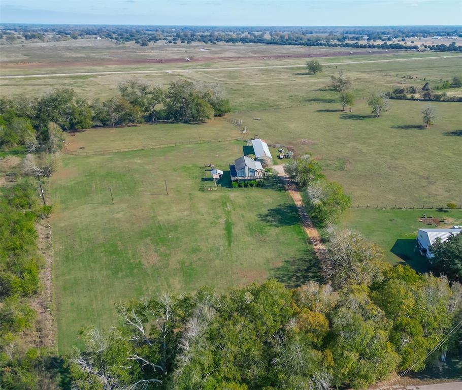 4502 Gainsborough Drive Brookshire, Texas Welcome to your own slice of paradise! This 9.29-acre property in Brookshire, TX will be your dream come true if you love the outdoors! With plenty of room for horses and other animals, this property is an animal lover's paradise. The horse stables are already set up and ready to use. Enjoy breathtaking views from the wrap-around deck of the two-bedroom, two-bathroom home that overlooks nature's beauty. Enjoy cozy nights in front of the wood-burning fireplace. Enjoy your morning coffee on your covered porch while watching horses frolic in the stables behind you. Build your custom dream home while living in the existing home on this beautiful piece of land. With plenty of room for animals or additional structures, this property offers a unique opportunity to create your custom dream home exactly how you want it! The possibilities are absolutely endless! Don't miss out on this rare and beautiful piece of Texas land – come see it today!