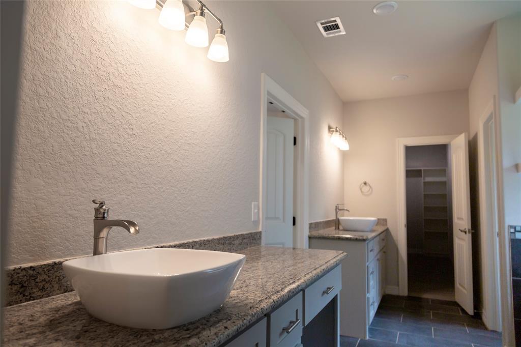 Primary bath has double vanity and double sinks with lots of cabinets space.