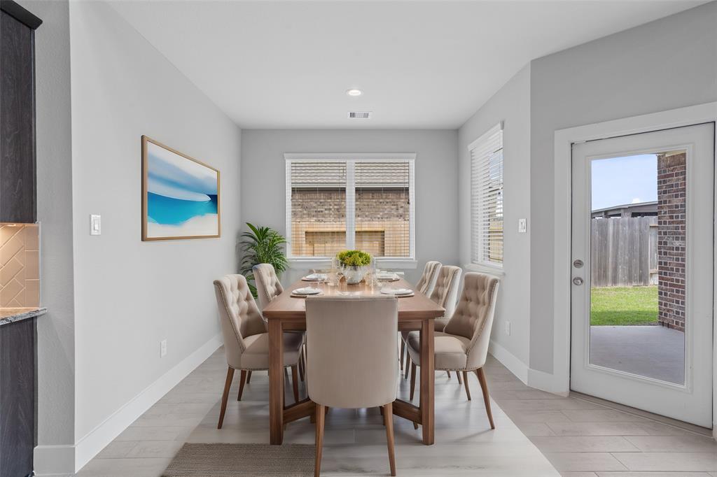 Start your day off right with a cup of coffee sitting with your family in the lovely breakfast area! Featuring large windows with blinds, custom neutral paint, gorgeous flooring, recessed lighting and high ceilings.