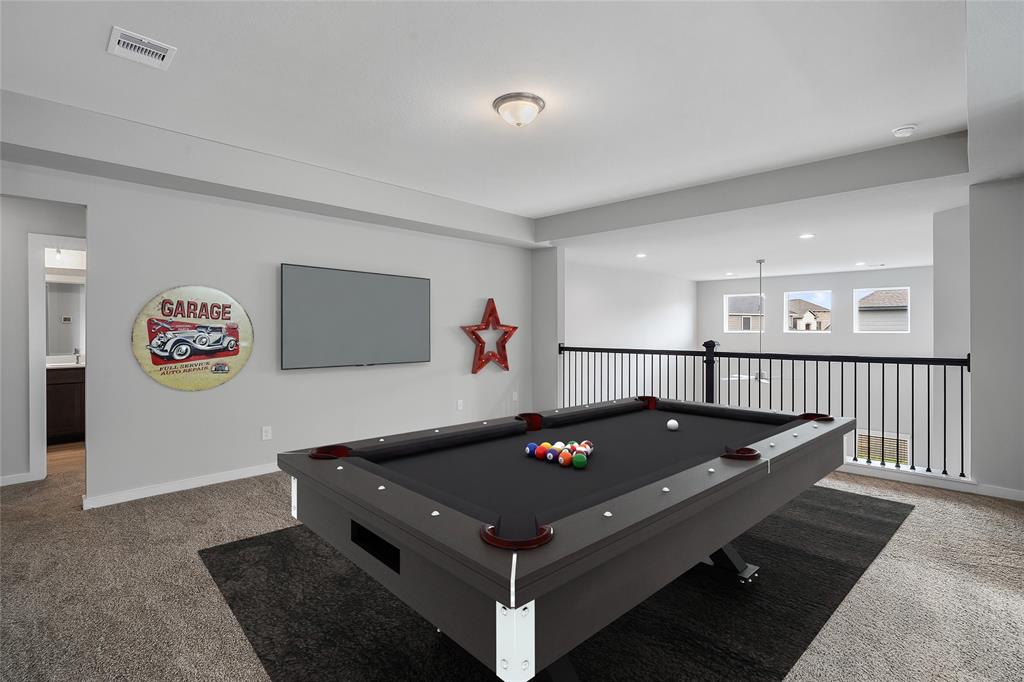 Perfect for entertaining is this amazing game room! Featuring plush carpet, high ceilings, custom paint and large windows.