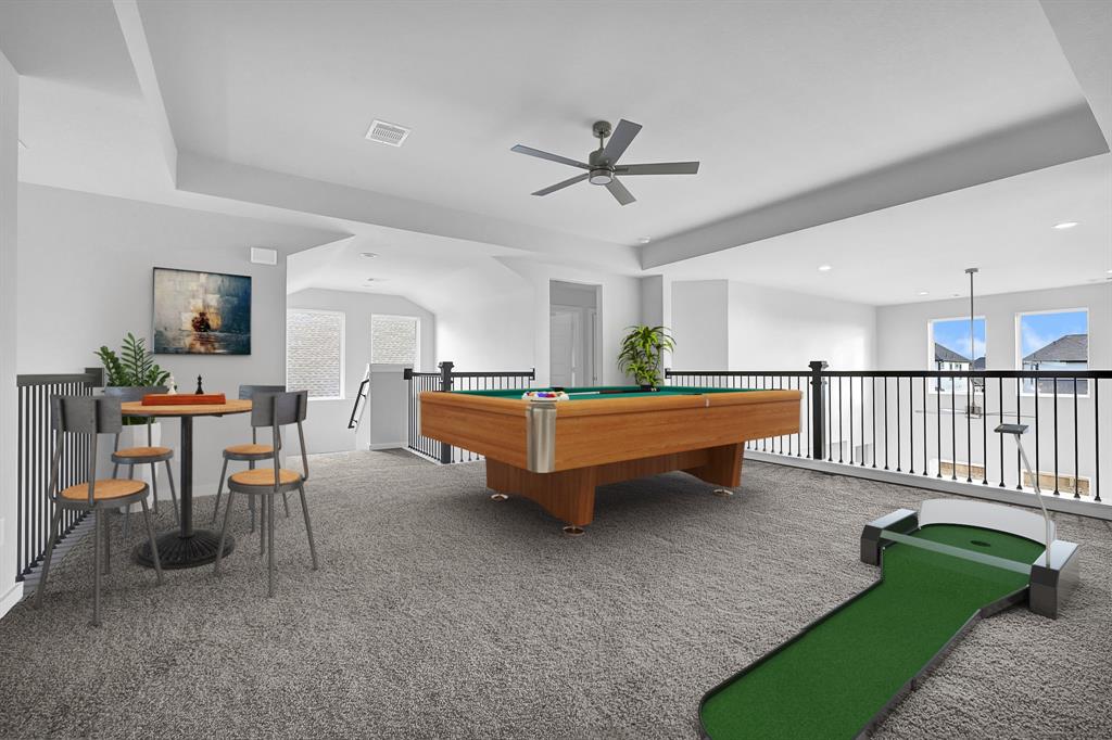 Come upstairs and enjoy a day of leisure in this fabulous game room! This is the perfect hangout spot or adult game room, this space features plush carpet, high ceiling, custom paint and ceiling fan.