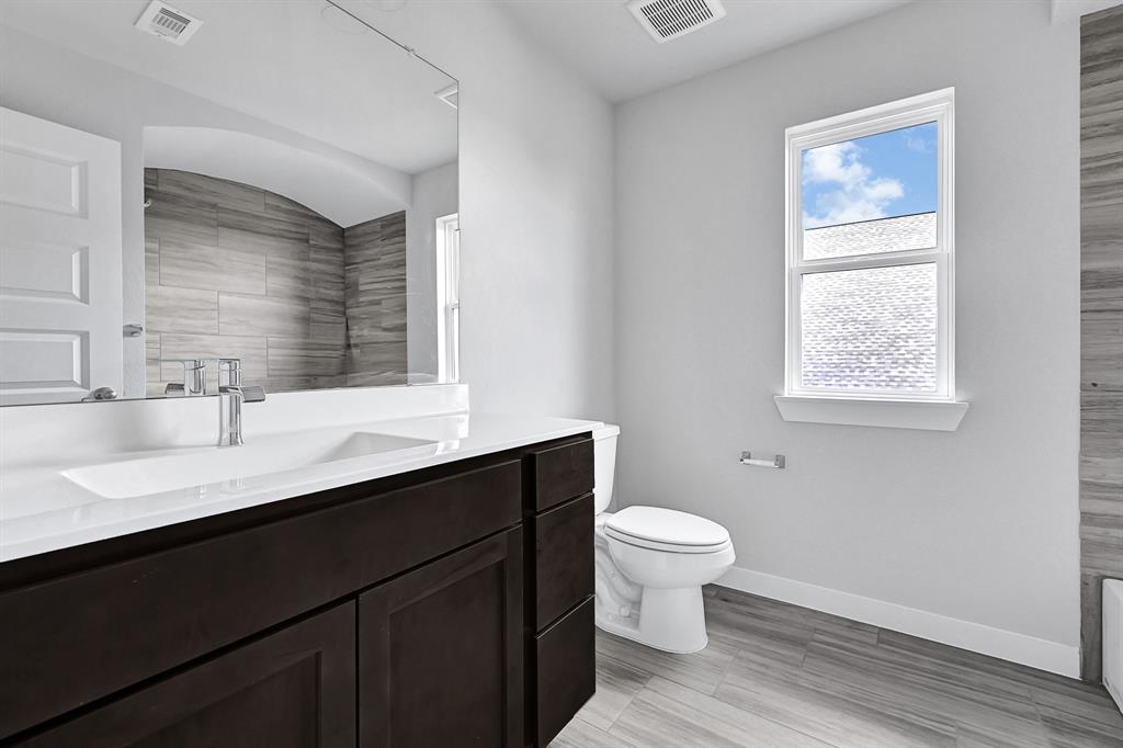 Secondary bedroom features plush carpet, neutral paint and a large window.