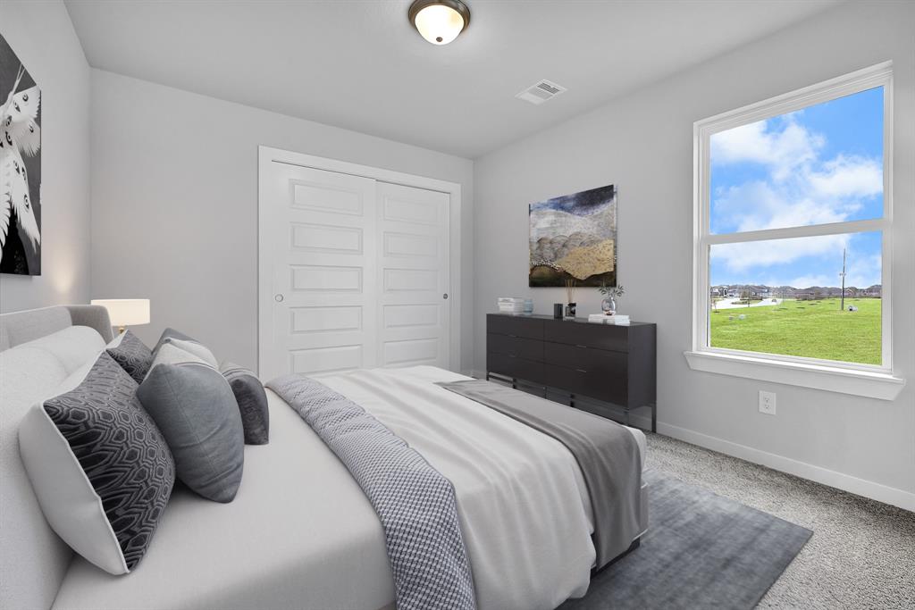 Secondary bedroom features plush carpet, neutral paint and a large window.