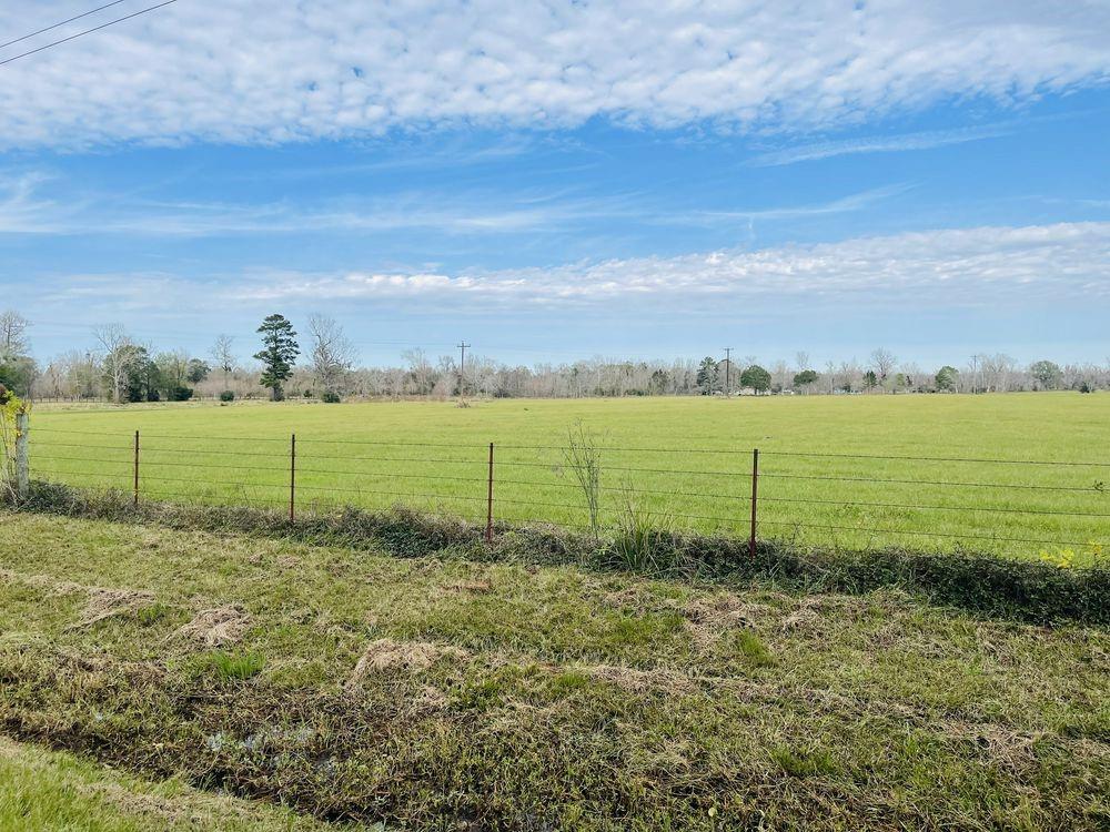 Liberty County 11-acre tract in a great location, on the corner of 2089 & 2095 is vast, cleared, and in the quietest area. The 11 acres are on the corner of CR 2089 & CR 2095 in Liberty, TX.  Unlike most raw land, this lot has access to local water and electricity.   Currently this property has an ag exemption for the 2023 tax year (due Jan 1, 2024). 2024 will require an exemption renewal.  The county will install the  20-foot-wide  apron driveway, culvert and crushed concrete single access across the drainage ditch on CR 2089.  This property is unrestricted however neighborly regarding consideration of developed land; preference on, post-frame, and metal exterior structures, barndominiums,  craftsman and ranch styles.  No mobile homes or manufactured homes due to property restrictions.  You'll find peace and tranquility so come and build your dream home on this amazing tract of land.  Country feel vast views close access to city services and amenities and only 54 miles from Houston.