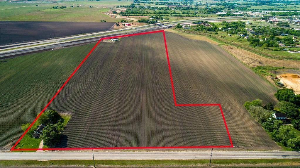HWY 59 FEEDER ROAD FRONTAGE!! Investment potential with this 22+/- acre tract . Also frontage along FM 1162. Perfect for hotel or manufacturing business!! Includes a domestic water well but is within city limits so city services could be obtained. The land is currently being leased to a tenant farmer. Zoned. So much investment potential!