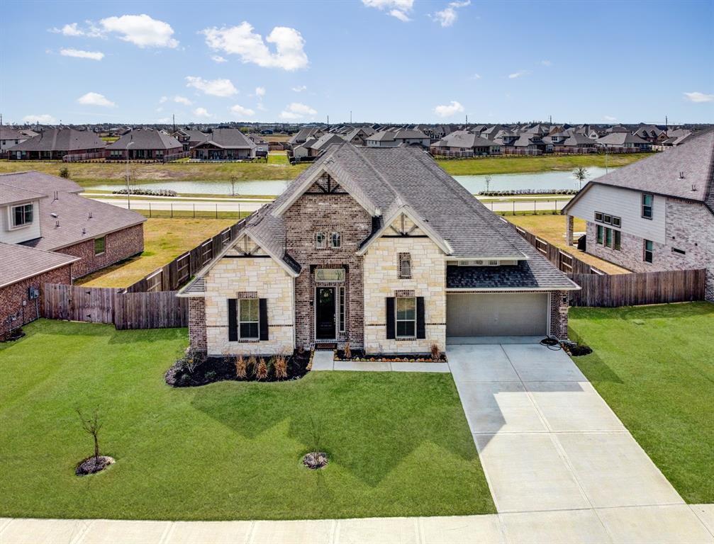 Don't miss out on this sought after Elaine floorplan home in the popular Lakes of Champions subdivision. Great Mont Belvieu location w/city services & close to all the schools. This beauty has it all: 4 bdrms, 3 baths, formal dining, office/study & bonus Flex Room. Why walk up & down stairs when you can have all the space you need in this 1-story home that boasts high ceilings, wood floors, cozy fireplace & a Kitchen that any chef would be proud of? Quartz countertops, herringbone designed subway tiled backsplash, under cabinet lighting, double ovens & farmhouse sink are just a few of the features in this Kitchen. Utility Rm. has plenty of space for folding clothes, sink for rinsing & a nice mud room area complete w/hooks & bench. Retire to your own Primary retreat as you look out towards the water from the breathtaking wall of windows & enjoy your adjoining ensuite w/freestanding tub, standup shower, separate sinks & make-up vanity. Huge covered back patio is perfect for entertaining.