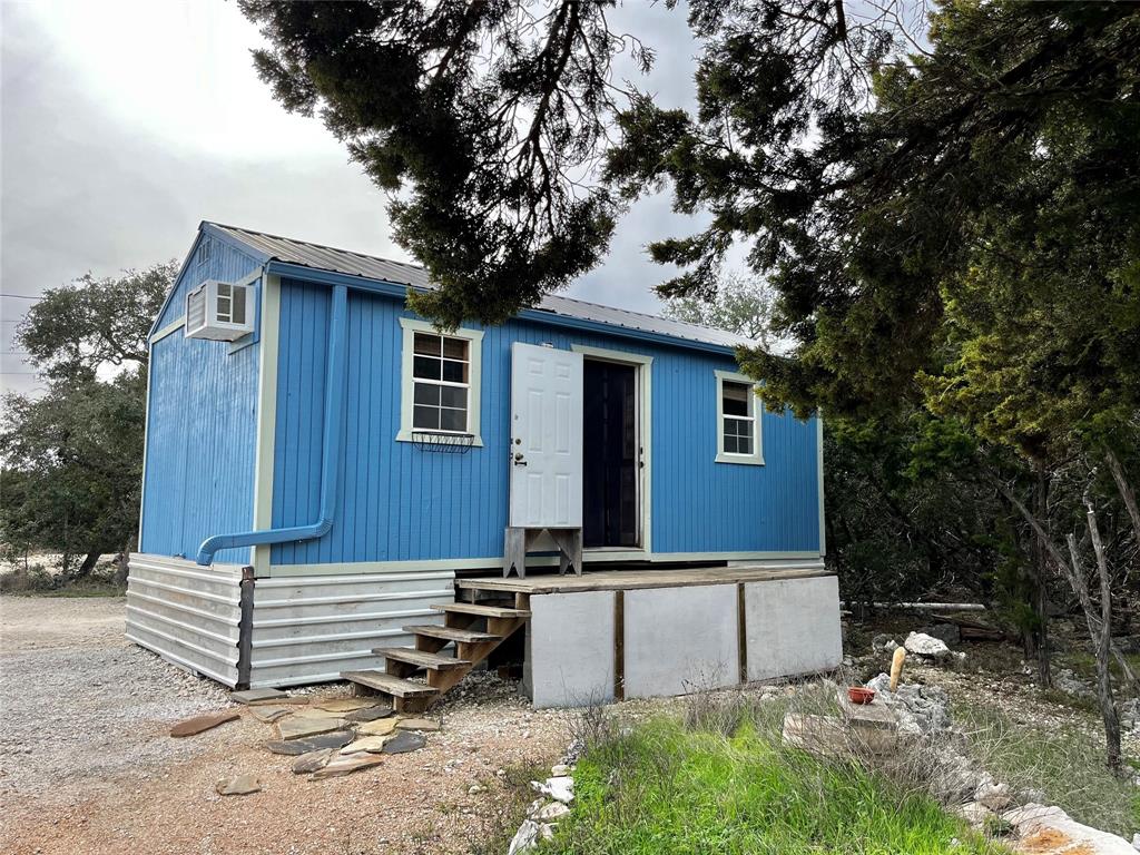 Pump house with W/D hookup, filtration system, and 2500 gallon rainwater tank ( to the right).