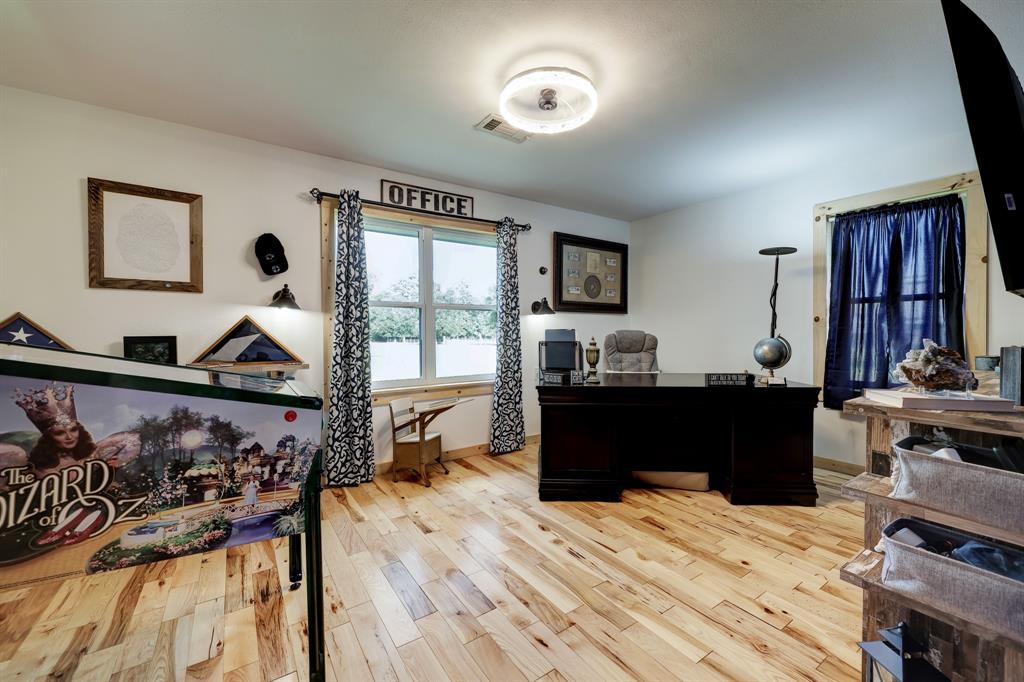 Behind the bookshelf door is this large guest bedroom, current owner is using it as an office.  Offers large wardrobe closet and 2 windows.