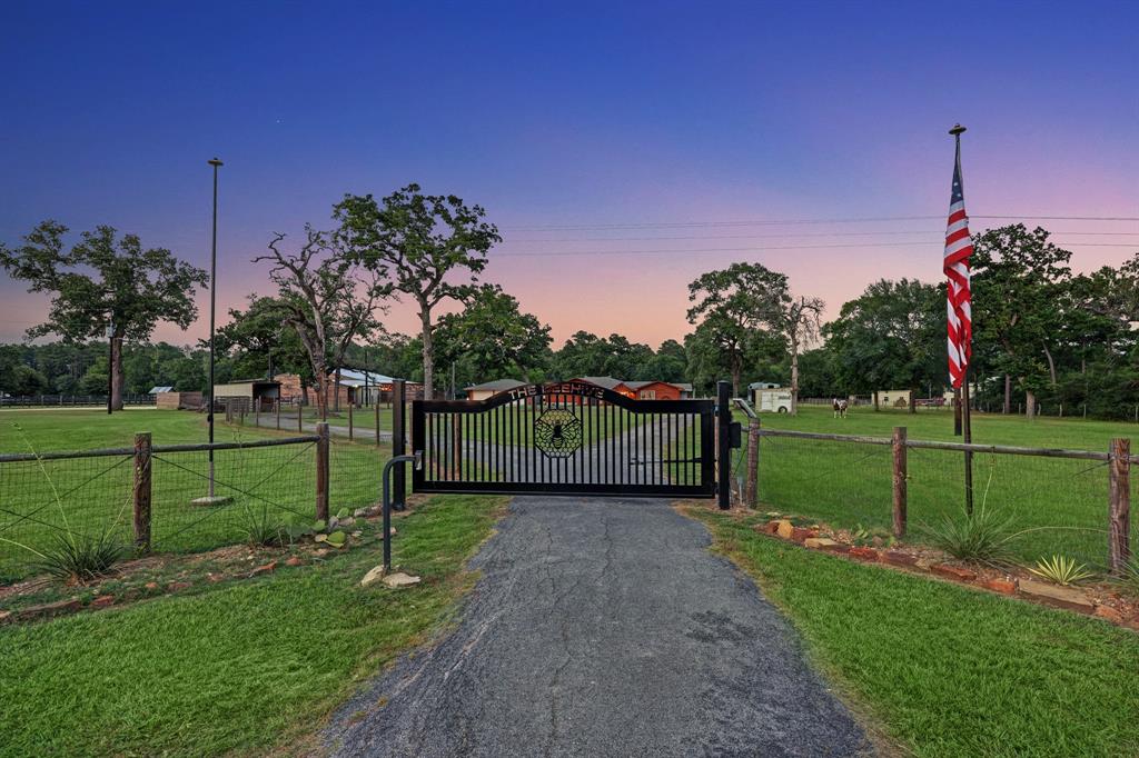 Custom Built Gate for this Estate situated on 6.4 Manicured Acres in Waller leads you to the main home on this circle drive way!