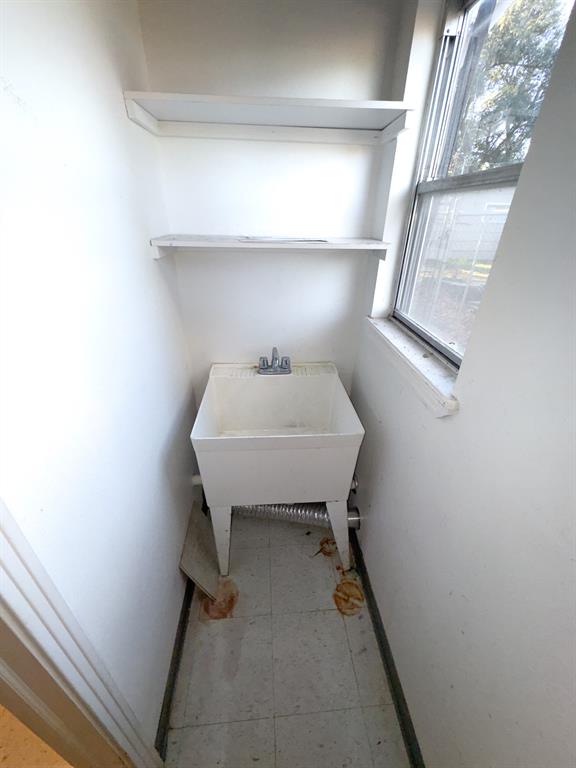 Sink closet attached to utility room