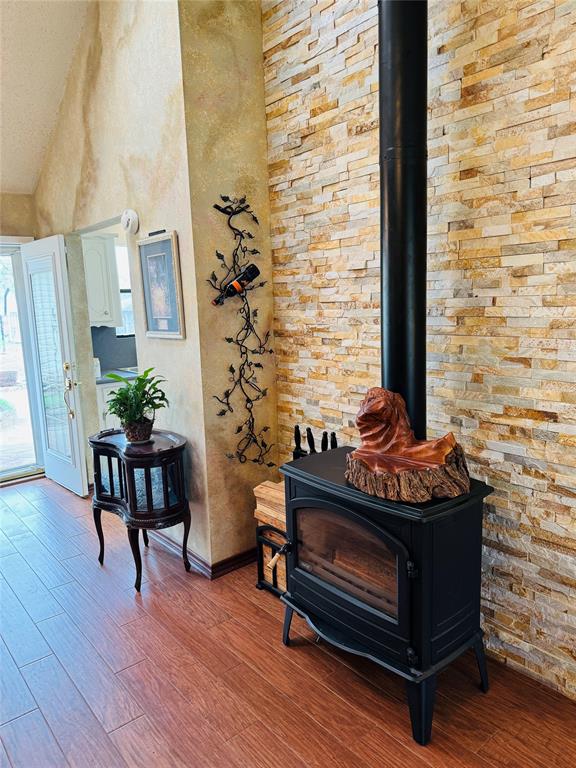 Real wood burning stove with beautiful stone wall.