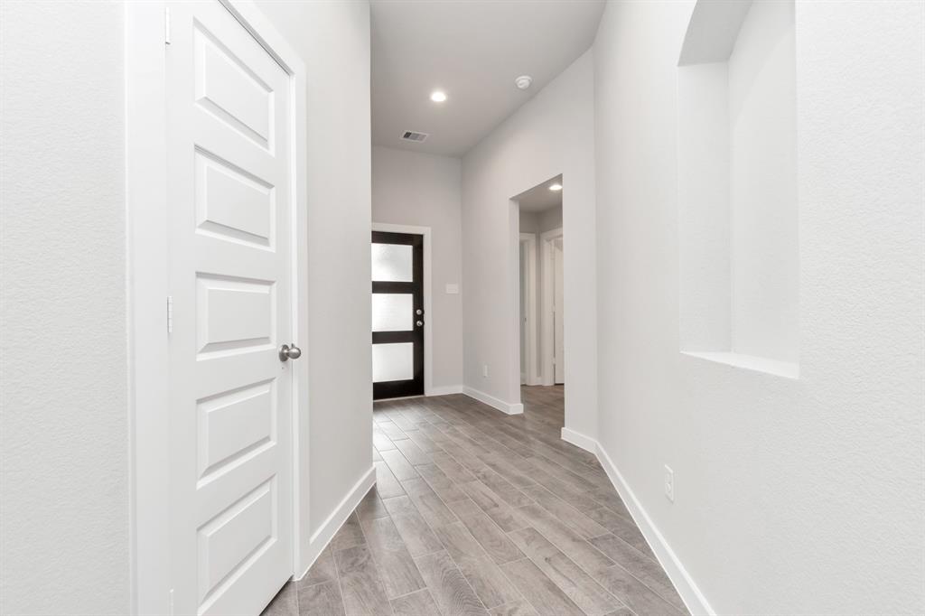 Welcoming ambiance and thoughtful wall accents, this hallway invites you to explore further into the heart of the home, promising comfort and tranquility.