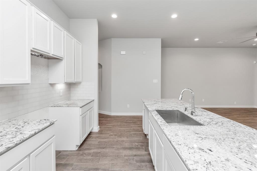 Discover another perspective of this stunning kitchen, generously appointed with an abundance of counter space