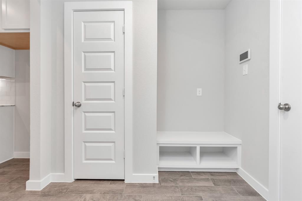 Dedicated mudroom next to utility and garage for added convenience.