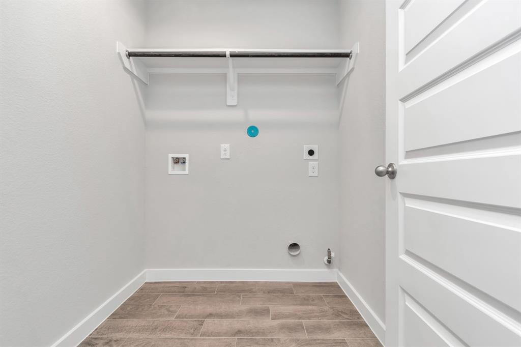 A perfect blend of functionality and comfort. Laundry room, thoughtfully equipped with shelving for effortless organization. Both gas and electric connections available.