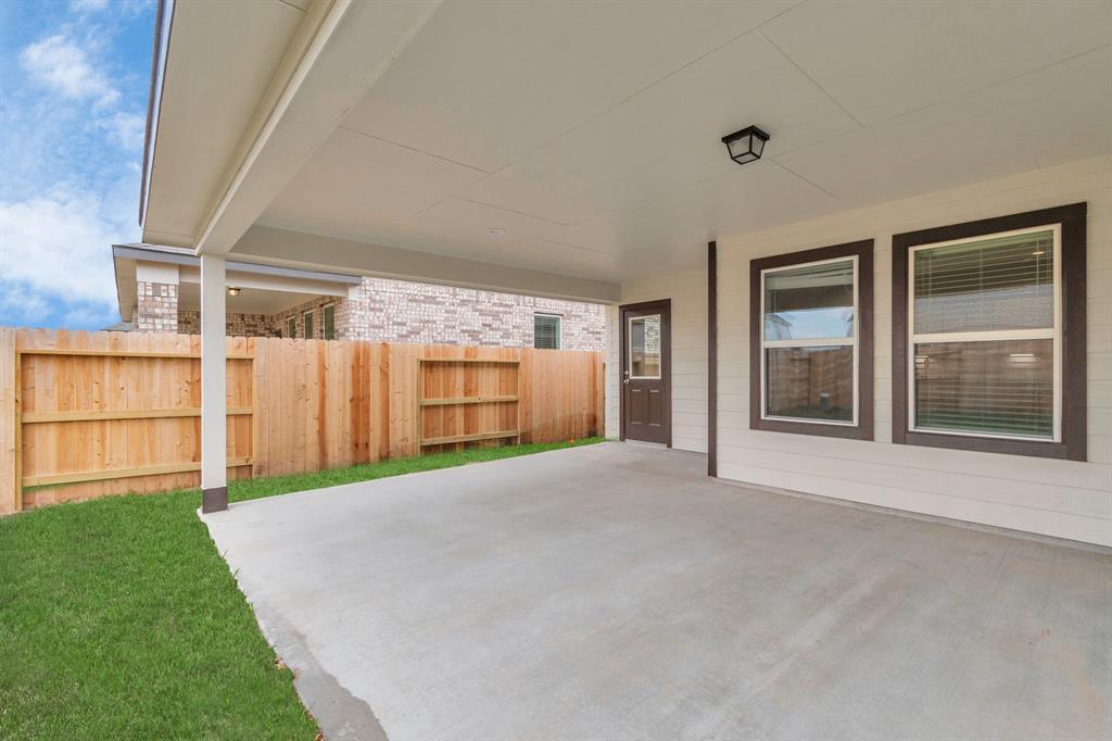 Experience outdoor living at its finest on this expansive covered patio, thoughtfully designed for BBQs and delightful outdoor dining