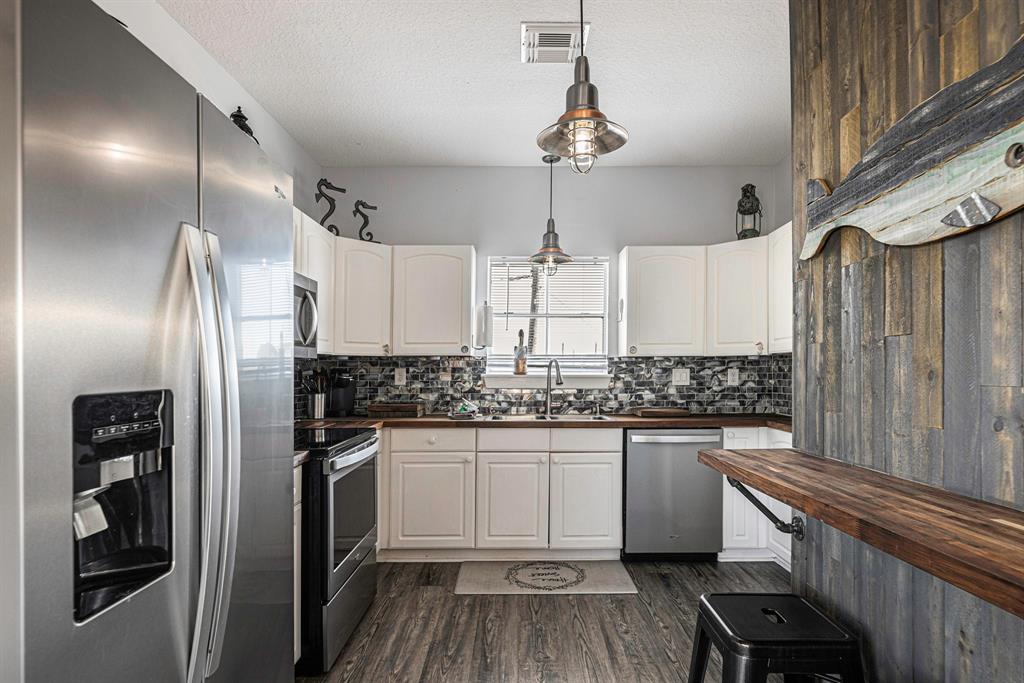 Kitchen with updated appliances and bar