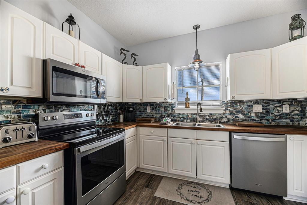 The kitchen has a view out to the back deck