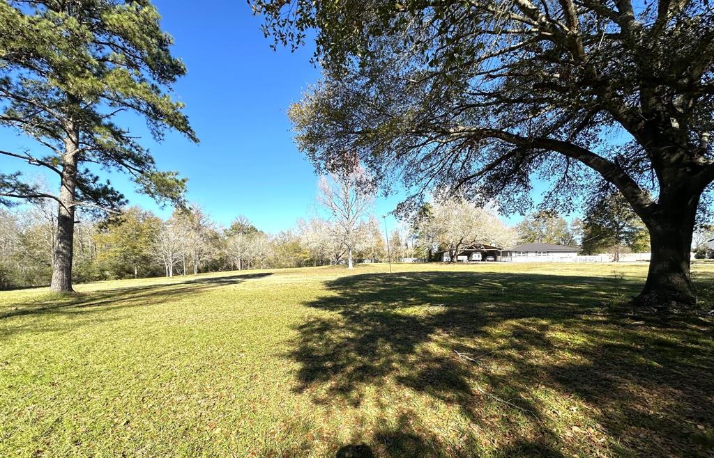 Welcome to a rare gem, 11 unrestricted acres inside the city limits of Trinity Texas. This beautifully kept property has a wonderfully remodeled 2-4 bedroom home, 2 full baths , and 3 car covered parking. Let's not forget to mention the swimming pool and outdoor kitchen to enjoy with your family and friends. There are 2 storage buildings, a huge barn, and chicken coop as well. This property will include a tractor with front end loader, box blade, and mowing deck, air compressor, log splitter and presplit fire wood for your fire place. With approximately 145 feet of highway 19 road frontage and the close proximity to town the commercial possibilities are only limited by your imagination. As a bonus FM 1617 runs along the back side of the property . Come enjoy the peace of the country, with the convivence of town or build a business such as an RV Park, Tiny house community or whatever your dreams lead you too. All measurements should be verified by purchaser.