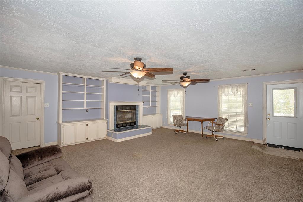 Spacious family room has built-in shelving and a wonderful fireplace.