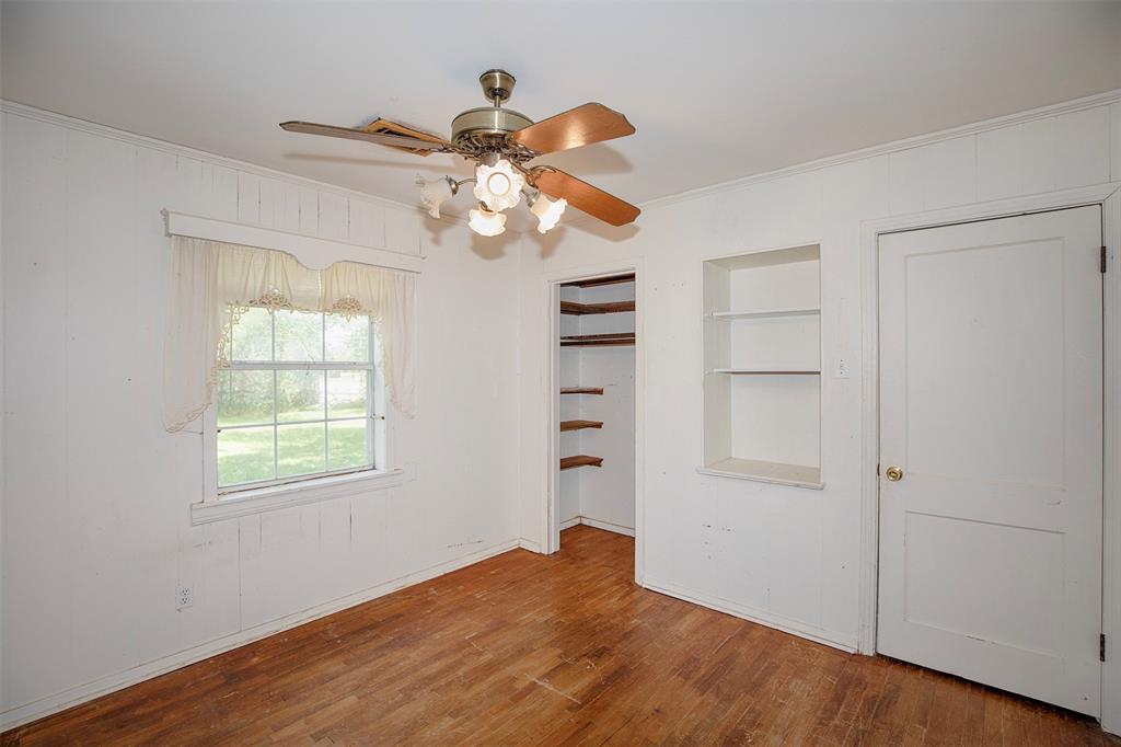 This bedroom has lovely wood flooring.