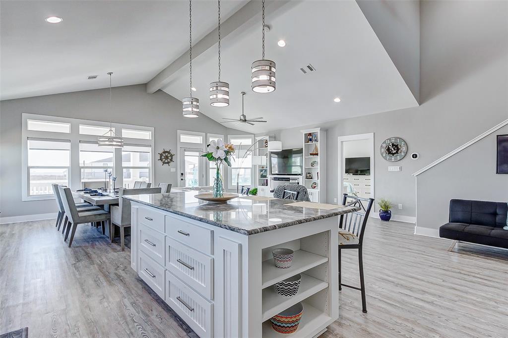 Another view of the Kitchen island, with Dining Room and Living Room in the background.