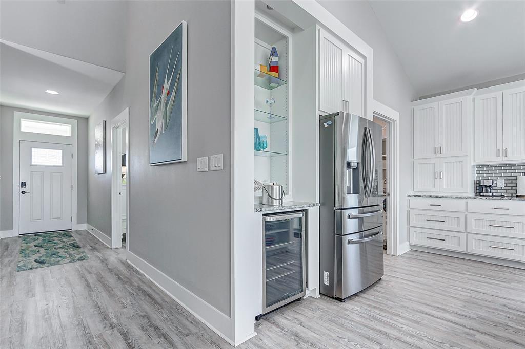 Foyer leading to the kitchen with wine fridge and cocktail/coffee bar.