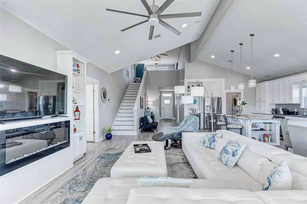 Living room with gorgeous fireplace, big screen TV and sectional sofa!