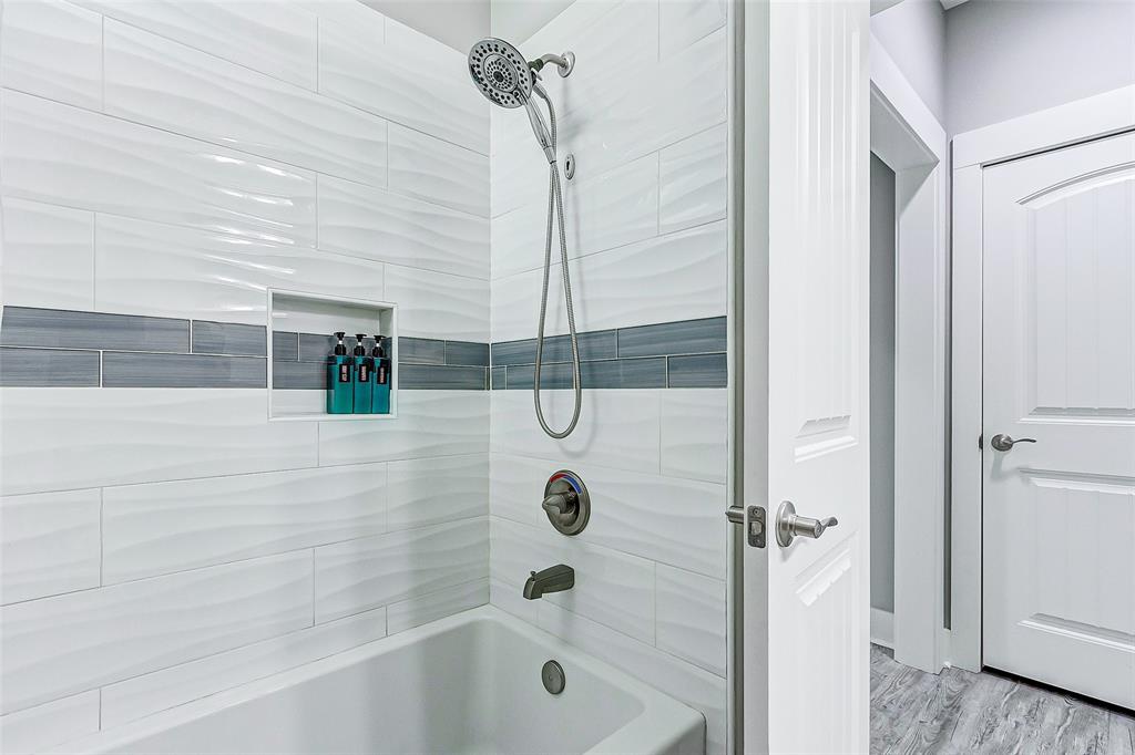 Tile shower and tub in Bathroom 2.