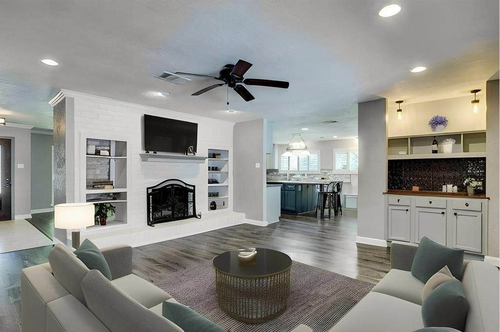 One virtually staged look of the den off of the kitchen. Dry bar for coffee and other beverages w/ additional storage for glass wear