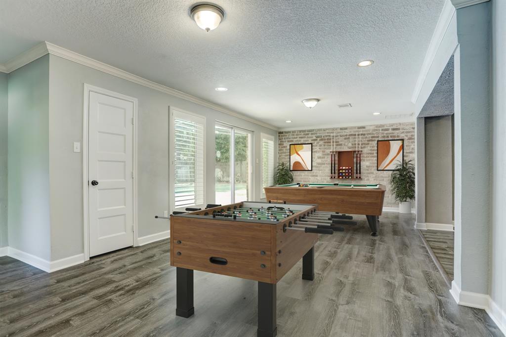 A second option for the game room that has a game closet and leads out to the pool- virtually staged