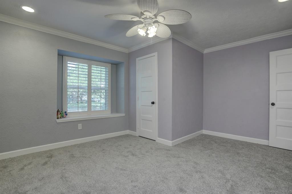 Front corner with large walk-in closet. View from the corner out to front yard. Seated window, ceiling fan, crown molding and NEW carpet