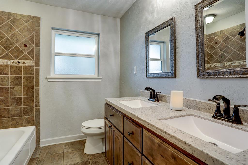 Secondary bathroom offers double sinks, and jetted tub, energy efficient frosted glass window