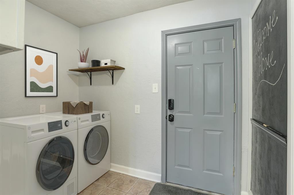 Virtually staged utility offer both gas and electric dryer hookup, powder room to the right and door out to breezeway/garage