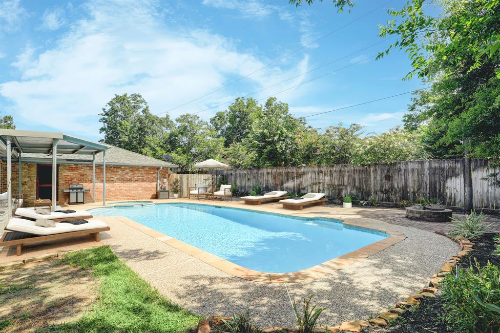 Look at this fun backyard! Includes covered patio and firepit